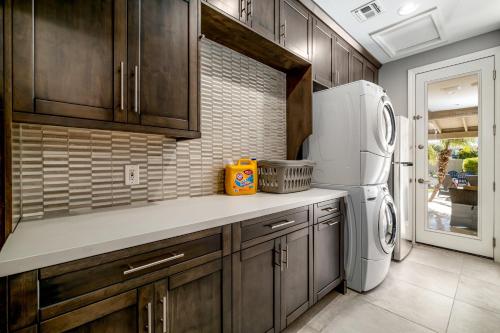 a kitchen with wooden cabinets and a white refrigerator at Northridge Mesa in Mesa