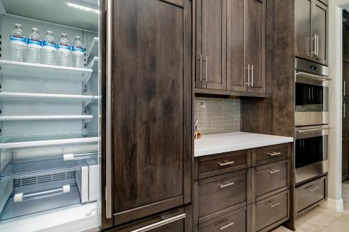 a kitchen with wooden cabinets and a refrigerator at Northridge Mesa in Mesa