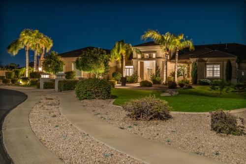 a house with palm trees and a driveway at Northridge Mesa in Mesa