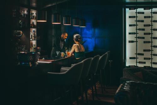 a man and a woman sitting at a bar at El Silencio Lodge & Spa Costa Rica in Toro Amarillo