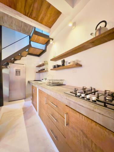 a kitchen with wooden cabinets and a stove top oven at Soul Dream Bonita in Las Terrenas