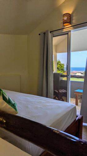 a bedroom with a bed with a view of the ocean at Nuevo NAYAL in Las Peñitas
