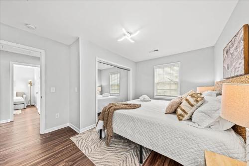 a bedroom with a large bed and a bathroom at The Mossy Oak House in Charleston