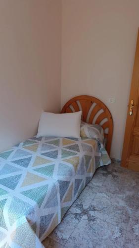 a bedroom with a bed with a pillow on it at Niodana in Candelaria