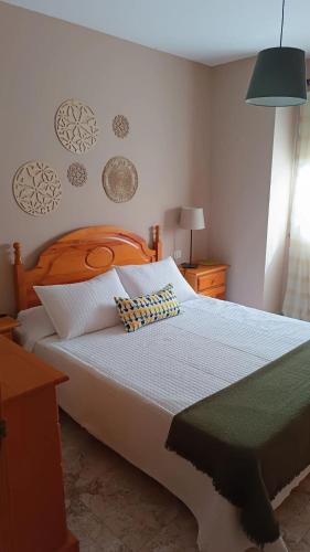 a bedroom with a large bed with a wooden headboard at Niodana in Candelaria