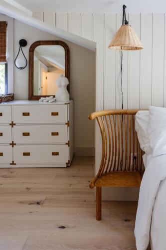 a bedroom with a dresser and a mirror at The Bend in Phoenicia