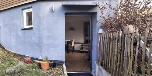 a door to a house with a fence at Wohnen am Weinberg in Rheinbreitbach