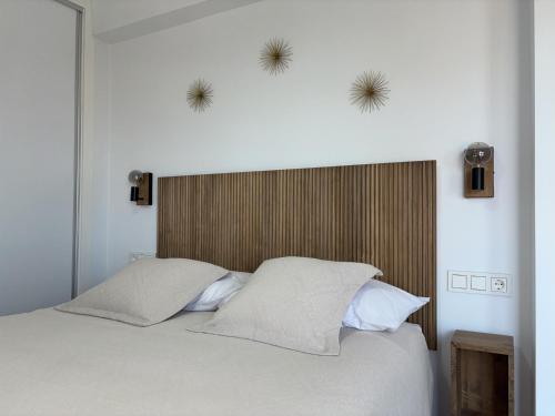a bedroom with a large bed with two pillows at Rincón del Mar in Cala del Moral