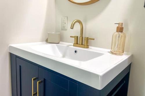 a bathroom with a sink with a soap bottle on it at Siren's Oasis 3 Bedroom Pet Friendly St George Island in St. George Island