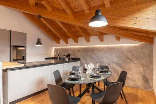 a kitchen and dining room with a table and chairs at Attico Fiera Milano in Rho