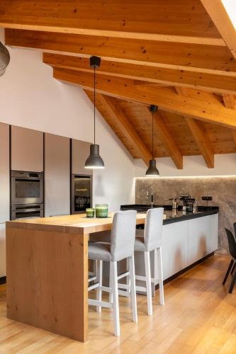 an open kitchen with a wooden table and chairs at Attico Fiera Milano in Rho