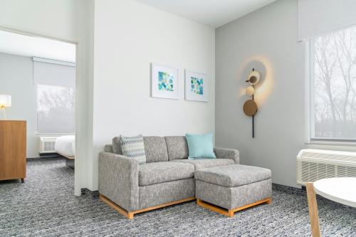 a living room with a couch and a chair at TownePlace Suites by Marriott Holland in Holland