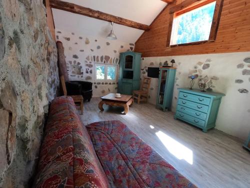 a living room with a couch and a table at Maison Maralpine in Roubion