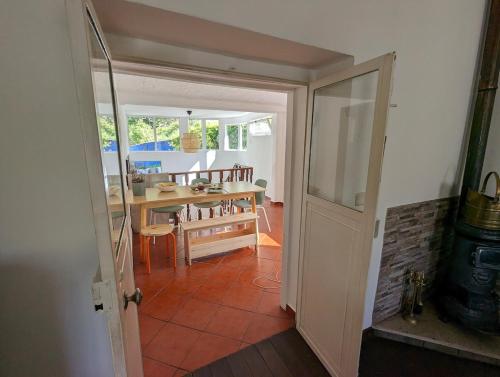 a view of a dining room with a table at Vila da Fonte - Peaceful 3-bedroom Villa with Private Pool, Central Portugal in Figueiró dos Vinhos