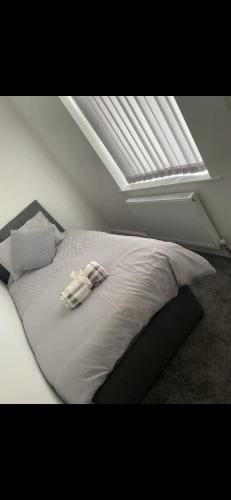 a bed with two towels on it in a bedroom at Denton House in Manchester