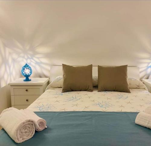 a bedroom with a bed with towels on it at Bufi de Nichilo locazione turistica occ. in Molfetta