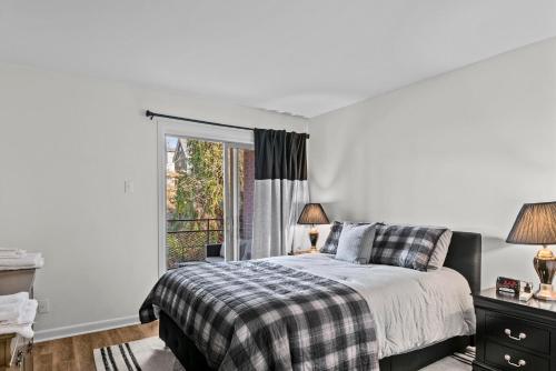 a bedroom with a bed and a window at Classic City Getaway at Stadium Village in Athens