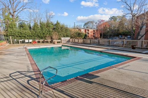 a swimming pool in a yard with a blue poolvisor at Classic City Getaway at Stadium Village in Athens