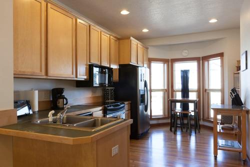 a kitchen with a stainless steel refrigerator and a sink at Venturi 30 day minimum in Hood River