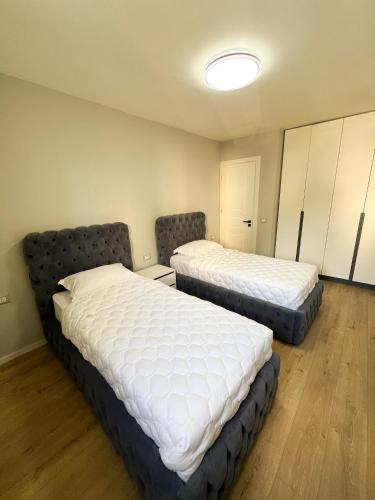 two beds in a small room with at Sea View Apartments in Durrës