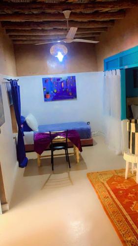 a room with a bed and a table in it at Maison ALPHEA SPA HAMMAM in Marrakech