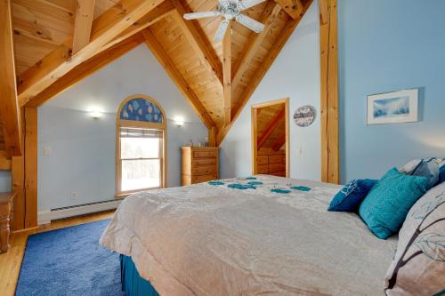 a bedroom with a large bed and a wooden ceiling at Secluded Vermont Retreat Outdoor Pool and Deck in Stratton