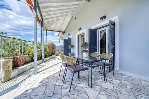 a patio with a table and chairs on a balcony at Katerina's Place in Argos