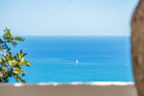 a sailboat in the ocean with a sail boat at Villa Antonella Amalfi Coast in Praiano