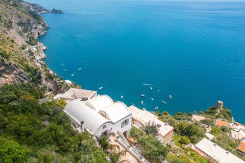 a large white building on the side of a cliff at Villa Antonella Amalfi Coast in Praiano