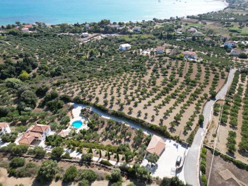 an aerial view of a resort with a river and trees at Methoni Vrisoules Poolvilla in Methoni
