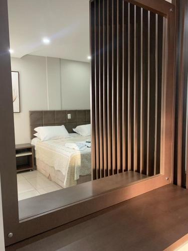 a bedroom with a bed and a large mirror at Prudentópolis Palace Hotel in Prudentópolis