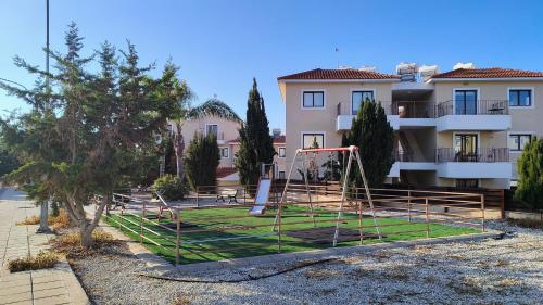 a playground in front of a apartment building at Déjà Blue Apartment Kyklades BC7 - workspace, pool, gym, nearby beach in Protaras