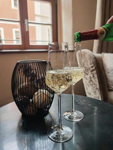 two glasses of white wine on a table at Pension Donatus in Pirna