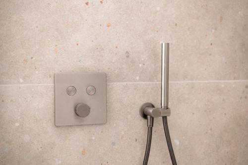 an electrical outlet on the floor of a bathroom at Cathedral View luxurious Apartment in Antwerp