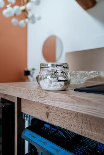 a glass jar sitting on top of a counter at Le Chat Léon in Chalon-sur-Saône