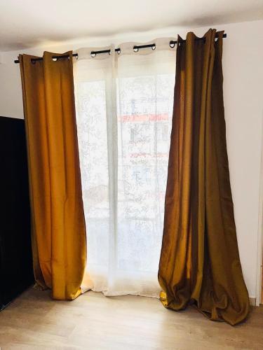 a pair of curtains in front of a window at T2 ILONA - neuf, 8min airport in Saint-Denis