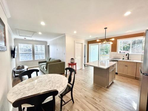 a kitchen and living room with a table and chairs at 2 Bedroom Apartment in SONO! in Norwalk