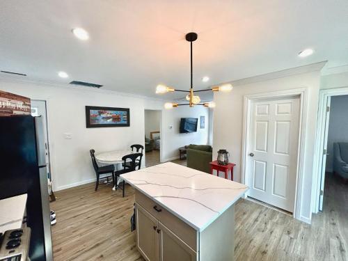a kitchen and living room with a table and a refrigerator at 2 Bedroom Apartment in SONO! in Norwalk