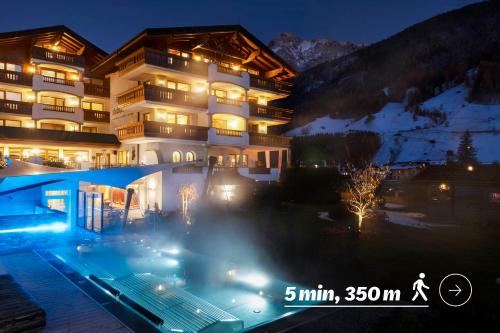 a building with a swimming pool at night at Sepp & Hannis Suiten im Dorf in Neustift im Stubaital
