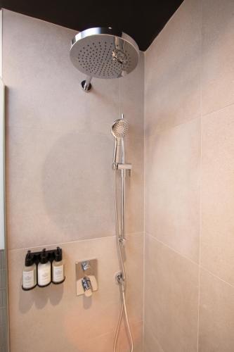 a shower with a shower head in a bathroom at Studio #5 - Self Check-In - Plateau - St-Denis in Montreal