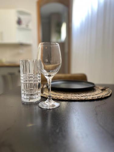 a glass of wine and a glass of water on a table at The Falcon in Windhoek