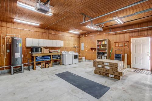 a large room with wooden walls and a kitchen at Adorable Dog Friendly Garage Apartment in the Historic District of Old Town in Fernandina Beach