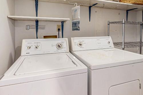 two white washing machines in a laundry room at Pensacola Beach Condos in Pensacola Beach