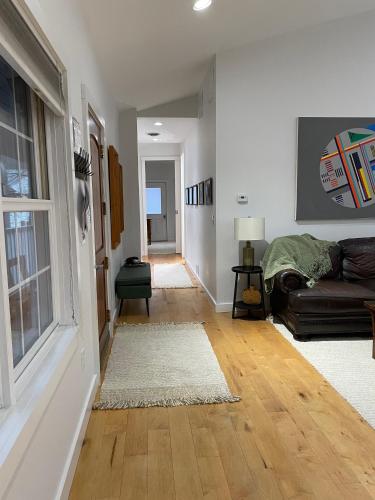 a living room with a couch and a window at Urban Peak Escape in Lenox