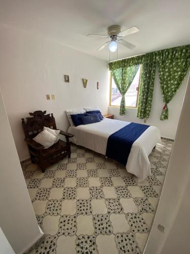 a bedroom with a bed and a ceiling fan at Casa María Isabel in Morelia