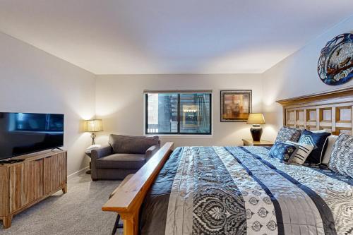 a bedroom with a large bed and a couch at Frisco Meadows in Frisco
