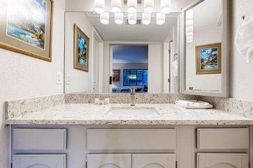 a bathroom with a sink and a mirror at Frisco Meadows in Frisco