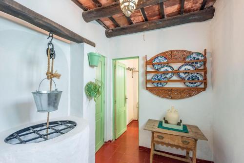 a hallway with a table and a pot on the wall at Casa Spa de la Mariola in La Puebla de los Infantes