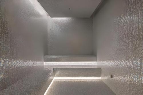 an empty room with a walk in shower with lights at Elite Brooklyn Living with Premiere Amenities in Brooklyn