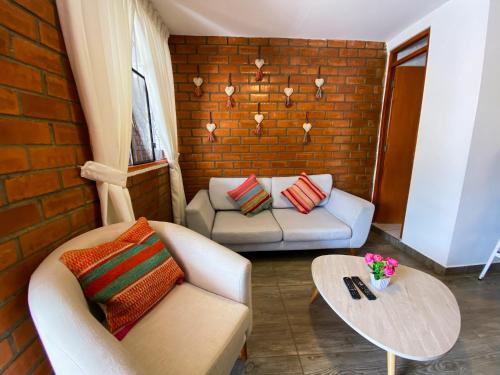 a living room with a couch and a table at Tupac Huaraz in Huaraz